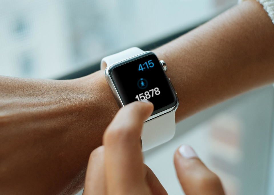 Bridge the Gap decorative image of woman checking smart watch with nearly 16,000 steps on it.