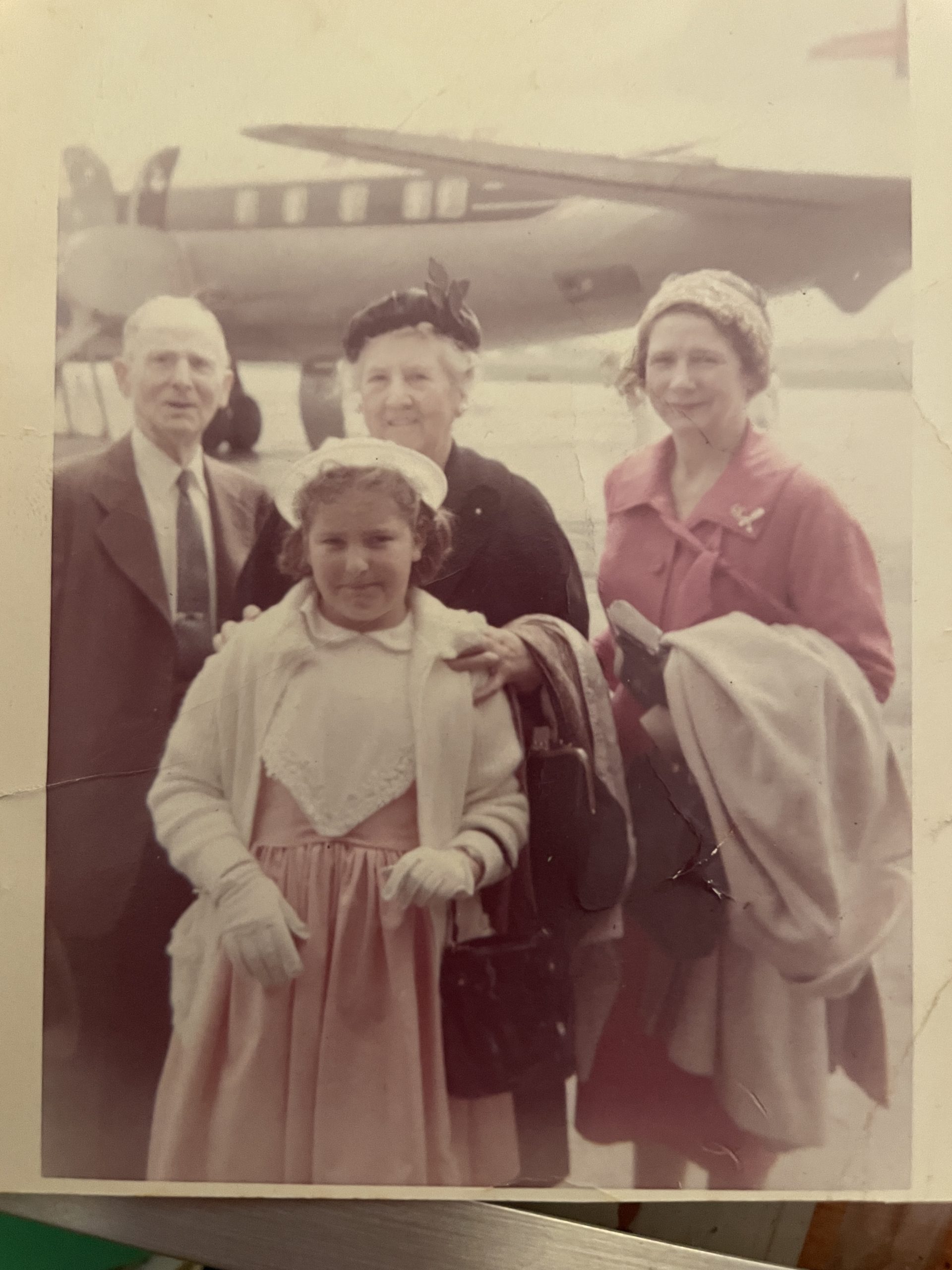 Old photo of a dressed up family going for a flight